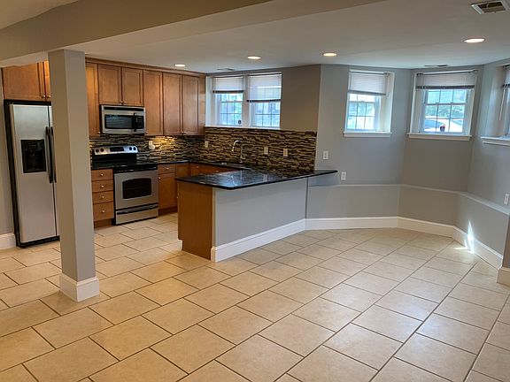 Updated kitchen, breakfast bar, and eat-in space with window views.