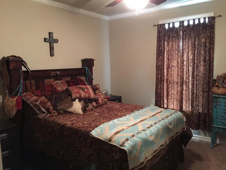 Representative Bedroom, bed and curtains left with tenant