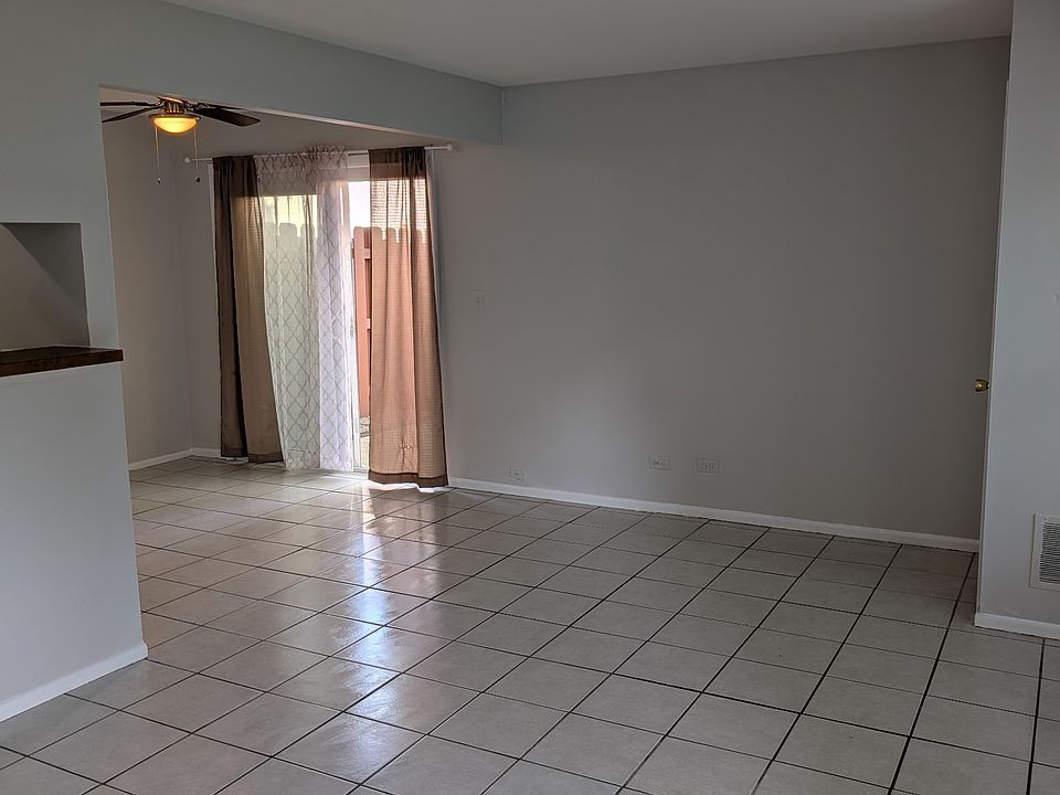 LIVING ROOM WITH KITCHEN AREA AND PATIO ENTRANCE DOOR