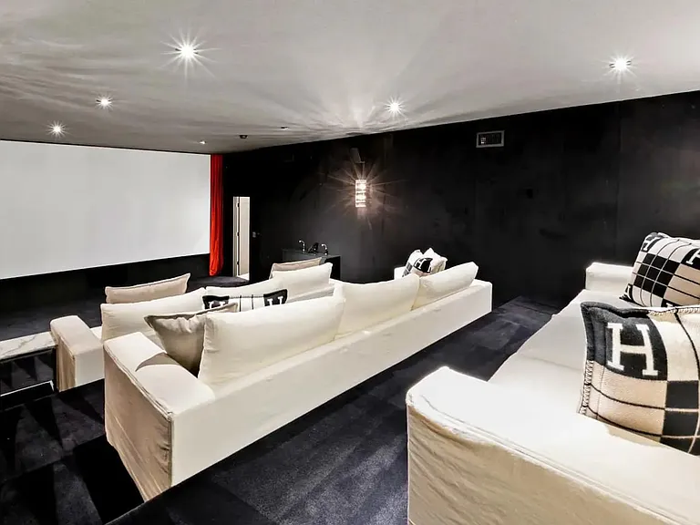 The spacious Theatre room with ample seating and pillows.