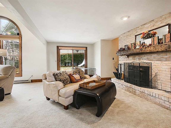 This side of the family room is anchored by the huge brick fire place with barn wood mantel and has