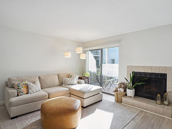 View of living room with fireplace and porch access.