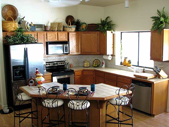 Bright and airy kitchen opens to the great room to easily ac