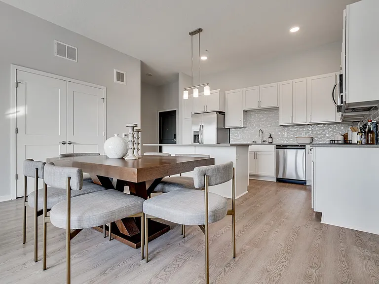 Dine in style with a chic table setup that flows effortlessly into the open kitchen.