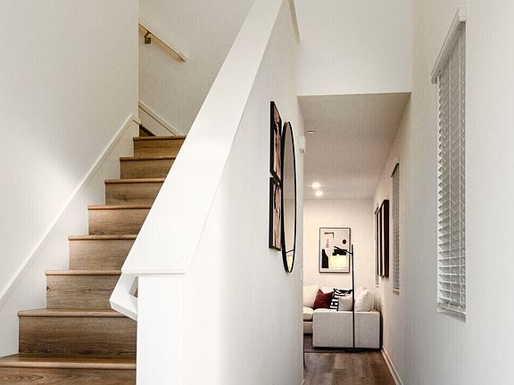 Plan 1A model home entrance with stairs and hallway