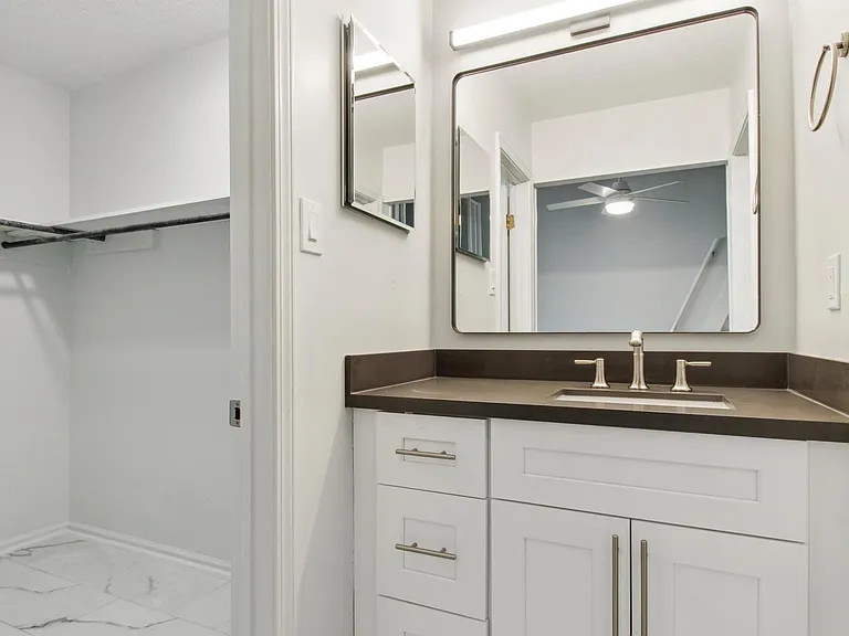 Front bedroom bathroom with brand new vanity, quartz countertops. All new faucet fixtures, built in medicine cabinet, designer mirror and light fixture with new towel racks. Large walk-in closet with marble floors!