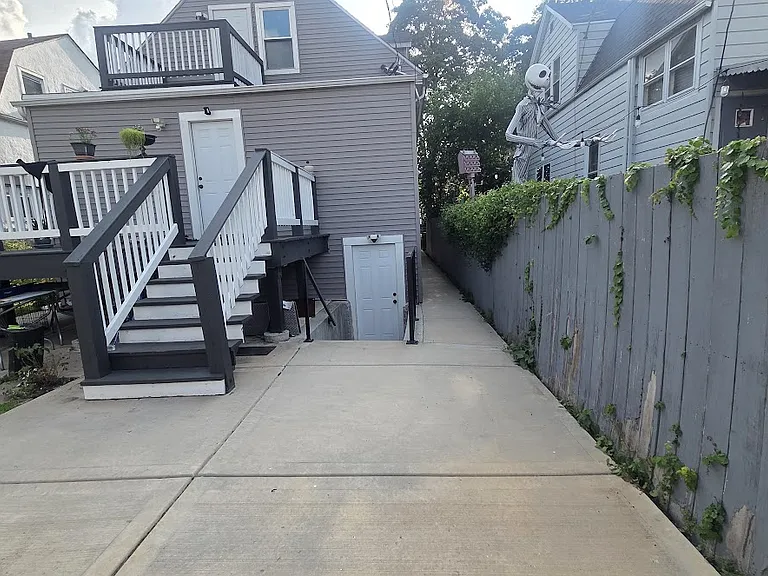 Back of the building with a separate entrance for the basement unit.