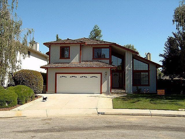Front with Murphy in Driveway