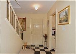 Entry view from the living area, showing door to the kitchen.