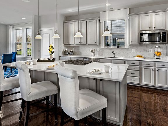 Open kitchen with large island in a DRB Homes Newbury II home plan at Huntfield.