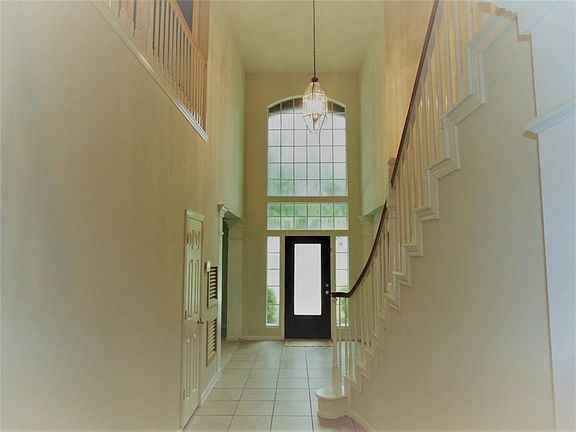 Beautiful Two Story Foyer offers a lovely spindle staircase. Interior of the home has been painted to a Neutral color.