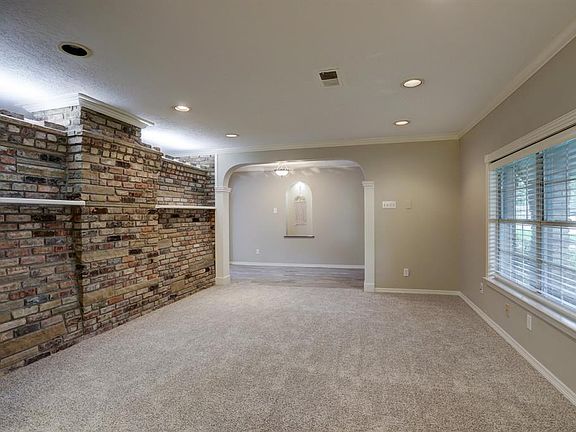 This is the very large living/dining combination as you enter. Imagine the possibilities of the brick wall painted..