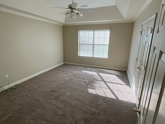 Trey ceiling with ceiling fan in master bedroom