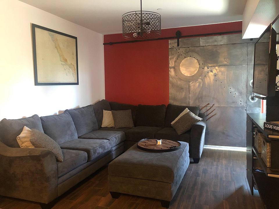 living room, large window behind sliding barn door