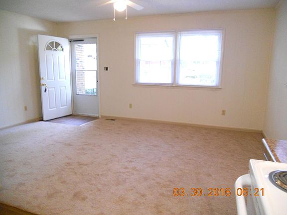 Den.Standing in Kitchen looking at front door.