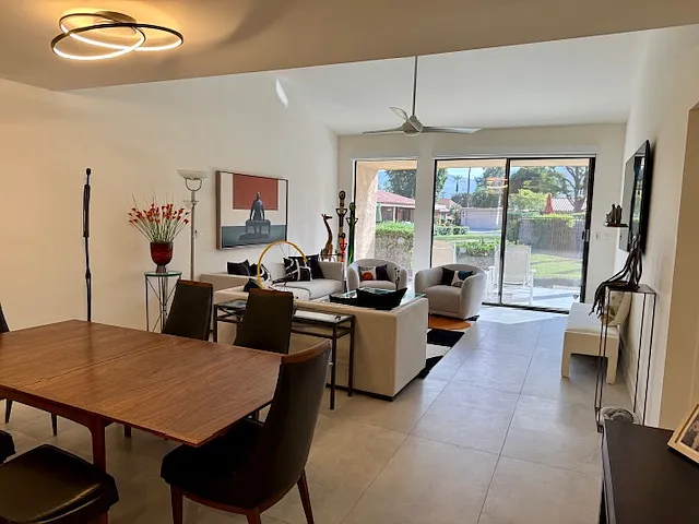 Dining/Living area with back patio, pool/spa to rear and mountain view.
