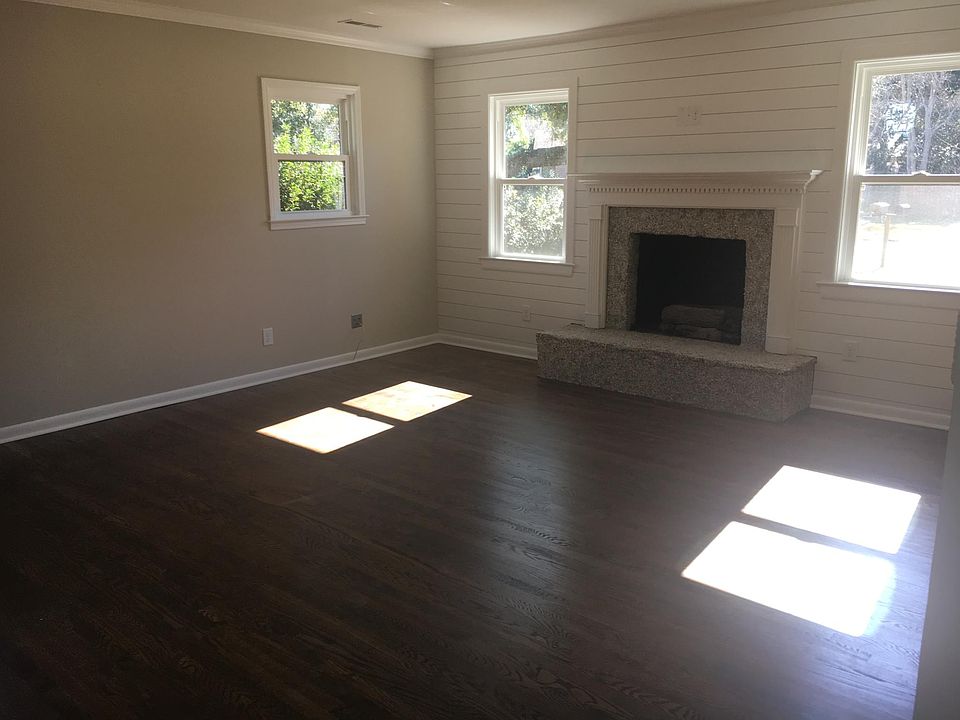 Living area with oyster shelled natural gas ventless fireplace and ship lap.