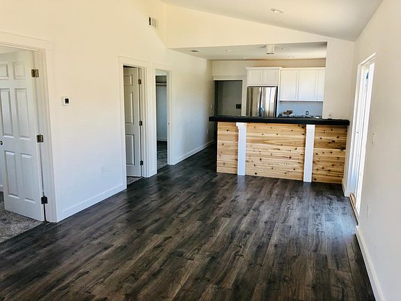 Along the wall of the Great Room Left door: Bedroom 1 Middle door: Main Bath Right door: Bedroom 2 The doorway at the back leads to the Master Bedroom and Bath