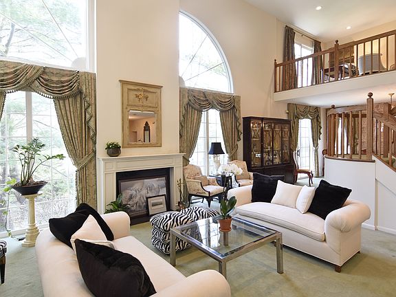 Living room with view of the second story bonus loft currently used as a sitting area.