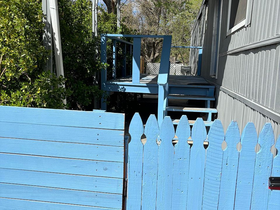 Side yard by entrance. Completely fenced yard for kids or pets.