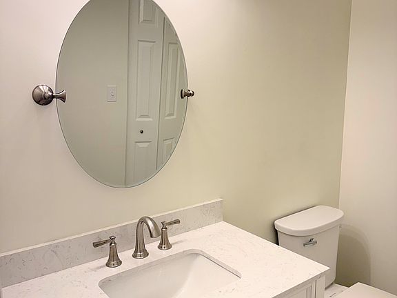 Recently renovated powder room with quartz countertop.