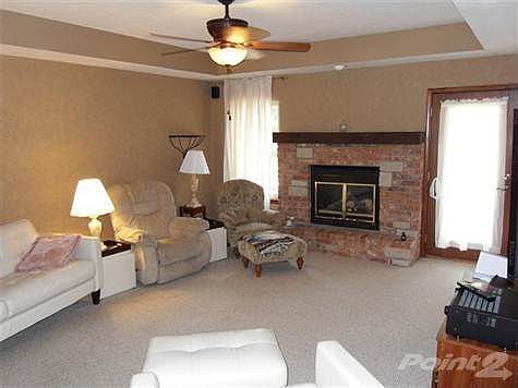 Fireplace featured in living room.