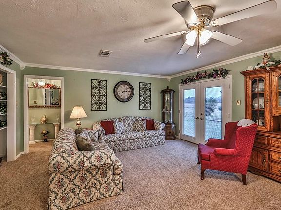 Living room features built-ins and french doors out to the back of the home.