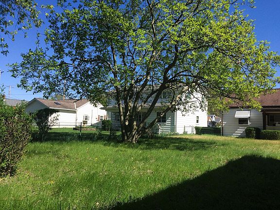 Large fenced back yard with magnolia tree