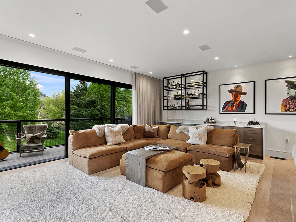 Living room with 10' Lift and slide stacking glass panel doors. Restoration Hardware Cloud sectional sofa
