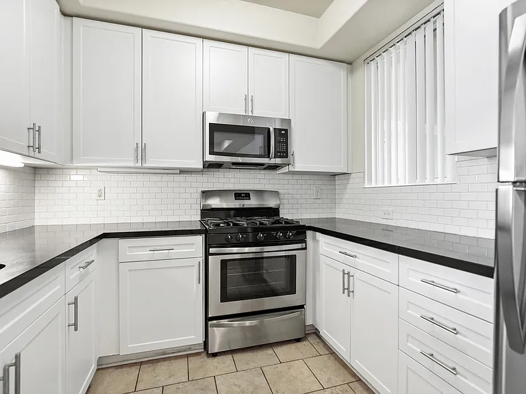 Kitchen with Stone Countertops, Stainless-Steel Appliances, and Ample Cabinet Storage