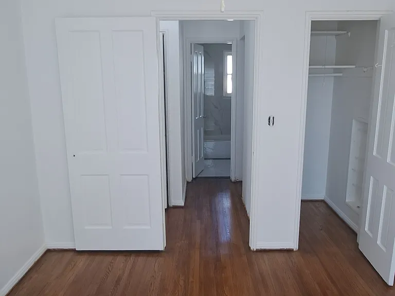 10'x13' Bedroom with ceiling fan, new curtains and window ac unit. New hardwood floors. Bedroom closet is 4'x3' with two shelf and shoe rack