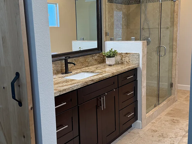Primary bathroom with bathtub, shower and his-and-hers sinks