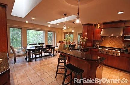 Kitchen
						:
						Granite countertops, tile floor, large skylights, and a view.