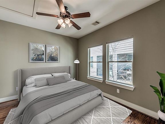 2nd floor, main living floor, is another spacious bedroom virtually staged over looking the patio downstairs. This room could make a nice study, studio, or even a murphy bed on the wall when you have overnight guests.