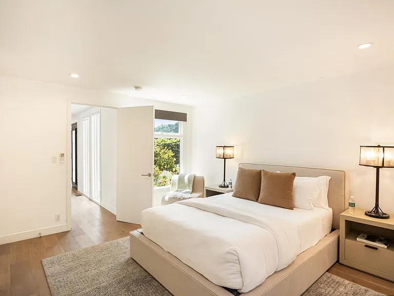 Featuring a lush bed adorned with crisp, fresh linens.