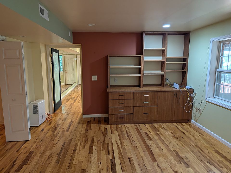 GREAT ROOM. It is connected to the MIRROR/ WINDOW ROOM. It has thebuilt in cabinet shown . To the left is another large room and to the right is a patio door to THE FLORIDA PATIO ROOM