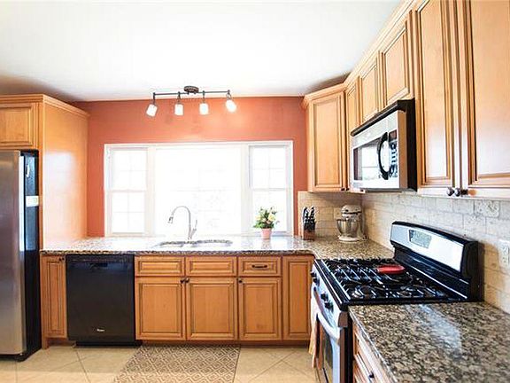 Kitchen with granite counter tops. Gas stove