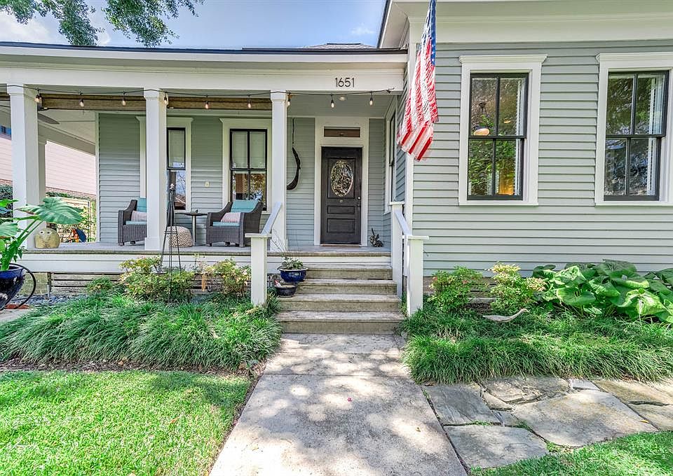 This picture perfect home sits on a huge lot at 1651 Columbia St right in the highly sought after Heights area! The entire property is a tropical oasis overflowing with vibrant landscaping. Its curb appeal is undeniable and its wrapped around front p