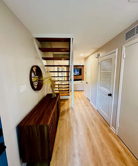 Step into an elegant entrance foyer that sets the tone for the rest of the home, featuring warm lighting and sophisticated design touches. To the right, you'll find the gourmet kitchen, thoughtfully designed for both function and style.