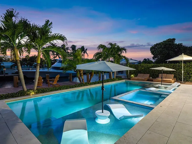 Luxurious loungers, tranquil water views, and the warm glow of a Florida sunset setting.
