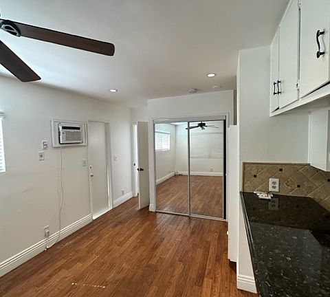Nice size living room open to the kitchen, with a mirrored closet for extra storage space!