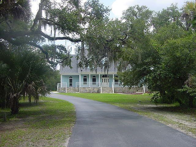 Midway down driveway looking at front of home.