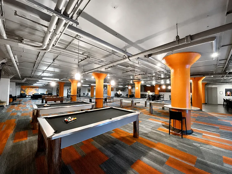 The "Q Room" includes ping pong, pool tables and foosball table. Also includes a full kitchen with island. Lounge area great for telecommuters. Stop by the Q Room for fun, or reserve it for events!