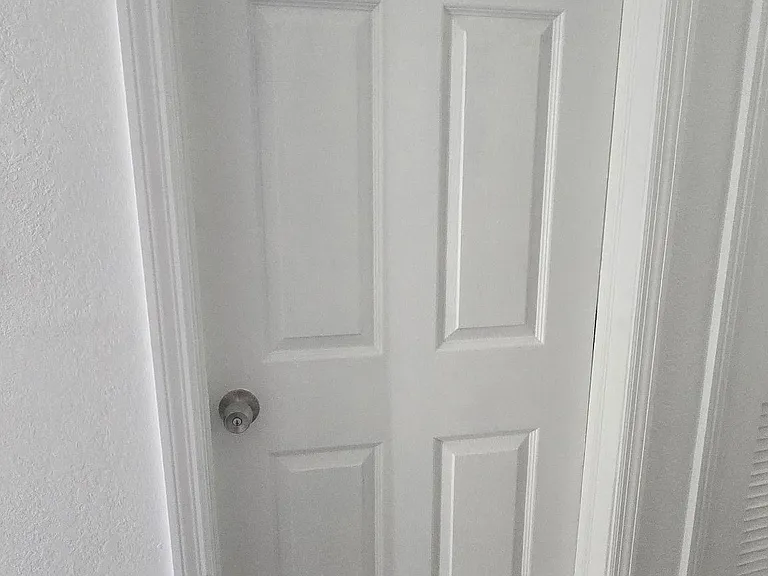 Interior hallway access with a labeled private door and durable flooring for easy upkeep.