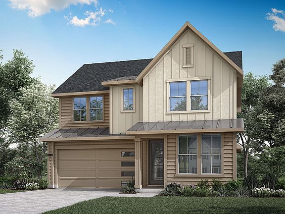 A two-story wooden house with a gabled roof, surrounded by lush greenery and a clear blue sky with s