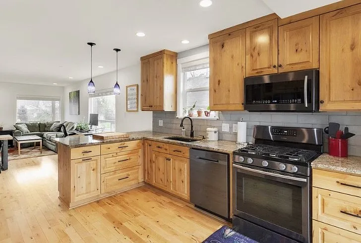 Beautifully remodeled kitchen with granite countertops, custom cabinetry and ample storage space. Modern appliances including a gas stove, dishwasher, built in microwave, refrigerator with filtered water dispenser and ice maker.