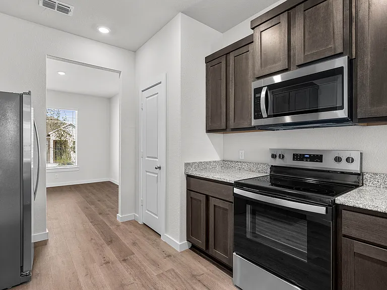 The kitchen has sprawling granite countertops.
