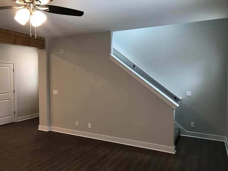 1st floor Living room with stairs to 2nd floor and 2 bedrooms.