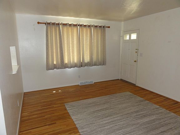Entrance door to living room. Pass room window to kitchen on left side wall.
