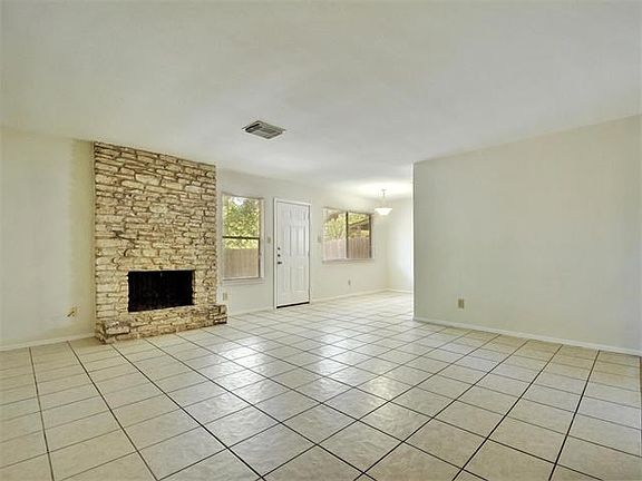 Home opens up to spacious living area with real fireplace.